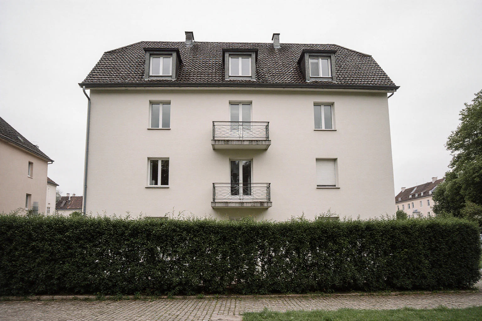 Mitteleuropäisches Mehrfamilienhaus mit Balkonen und gepflegtem Hof
